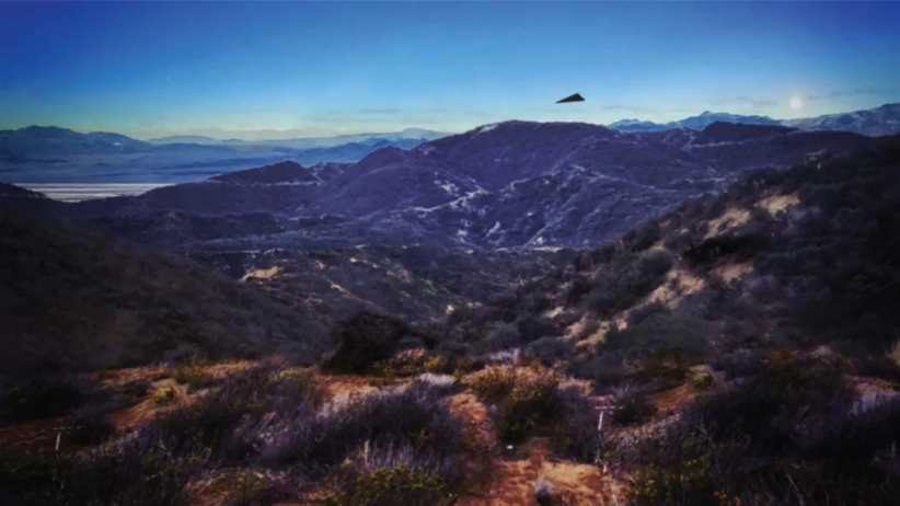 Digital reconstruction showing a dark triangular object above rugged mountain ridges beneath a clear blue sky.
